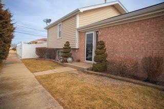 view of home's exterior with a lawn