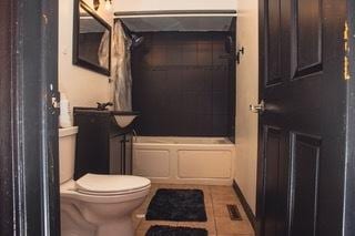 bathroom featuring tile patterned flooring and toilet