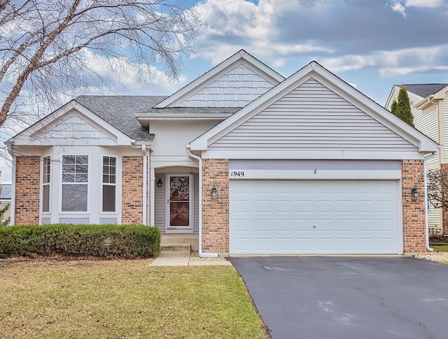 ranch-style house with a front yard, roof with shingles, brick siding, aphalt driveway, and a garage
