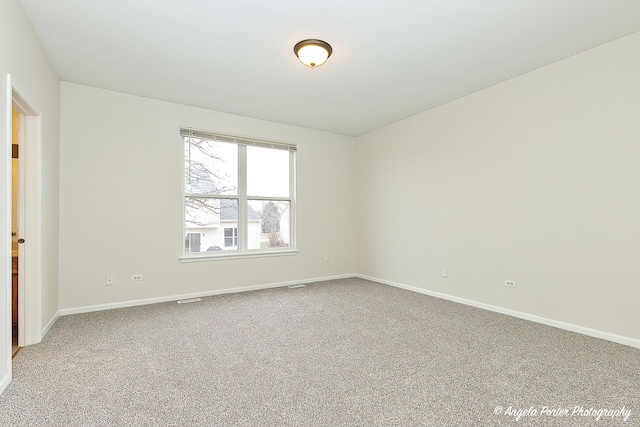 unfurnished room with carpet, baseboards, and visible vents