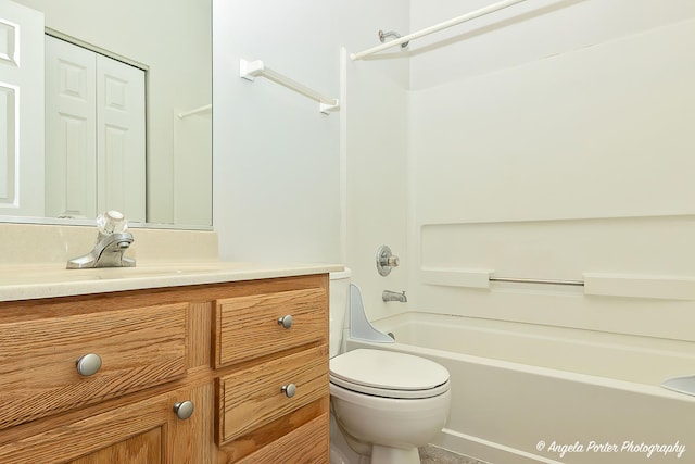 bathroom with toilet, vanity, and washtub / shower combination
