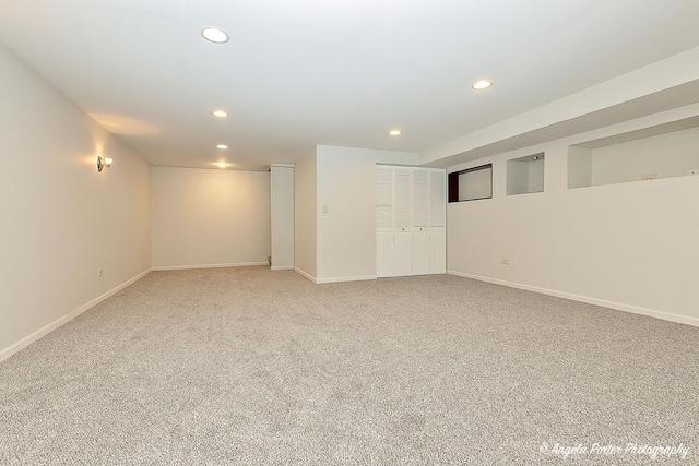unfurnished room featuring light colored carpet, baseboards, and recessed lighting