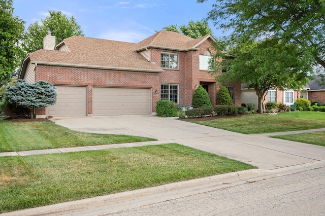 3444 Owens Ln, Dekalb, IL 60115 - traditional-style home featuring brick siding, an attached garage, driveway, a front yard, and a chimney