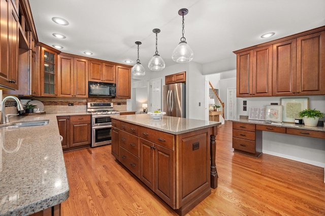 3444 Owens Ln, Dekalb, IL 60115 - kitchen with appliances with stainless steel finishes, light wood-type flooring, brown cabinetry, light stone counters, and recessed lighting