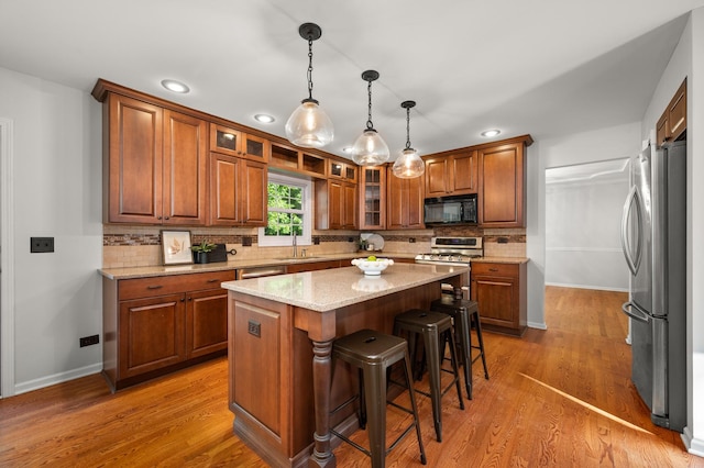3444 Owens Ln, Dekalb, IL 60115 - kitchen with stainless steel appliances, brown cabinets, decorative backsplash, light stone counters, and recessed lighting