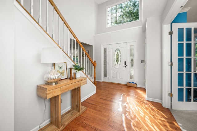 3444 Owens Ln, Dekalb, IL 60115 - entryway featuring stairs, a high ceiling, and wood finished floors