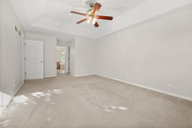 3444 Owens Ln, Dekalb, IL 60115 - unfurnished bedroom with a raised ceiling, light colored carpet, a ceiling fan, and ensuite bathroom