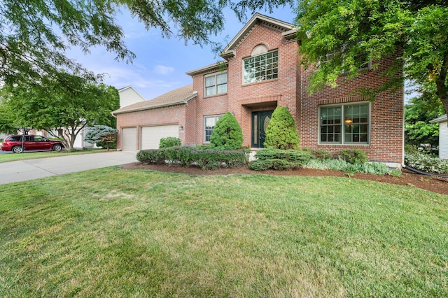3444 Owens Ln, Dekalb, IL 60115 - traditional home with brick siding, an attached garage, concrete driveway, and a front lawn