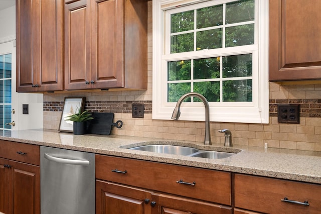 3444 Owens Ln, Dekalb, IL 60115 - kitchen with stainless steel dishwasher, light stone counters, tasteful backsplash, and brown cabinetry