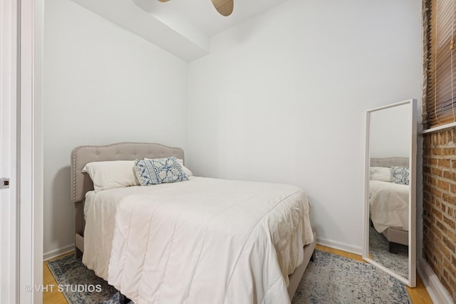 bedroom with ceiling fan, baseboards, and wood finished floors