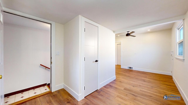 corridor with light hardwood / wood-style floors