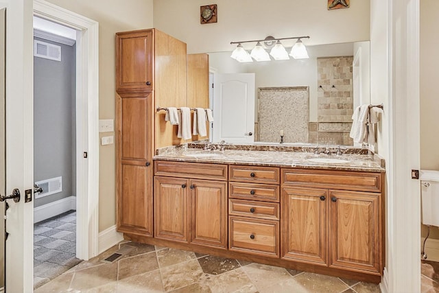 full bathroom featuring a sink, double vanity, and visible vents