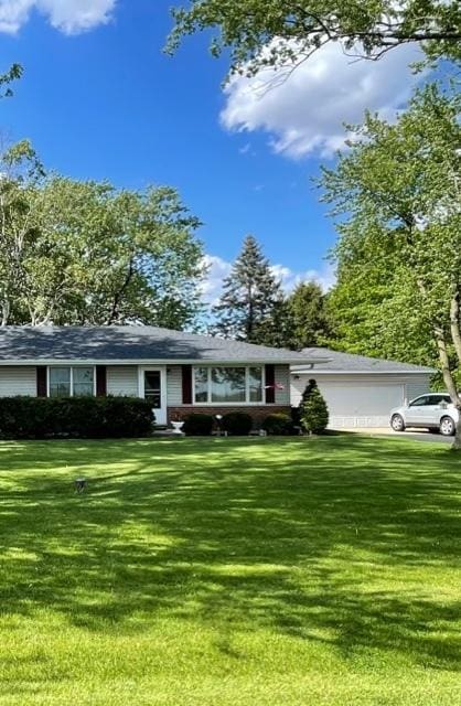 single story home with an attached garage and a front yard