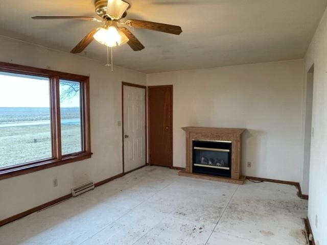 unfurnished living room featuring a ceiling fan, a glass covered fireplace, visible vents, and baseboards