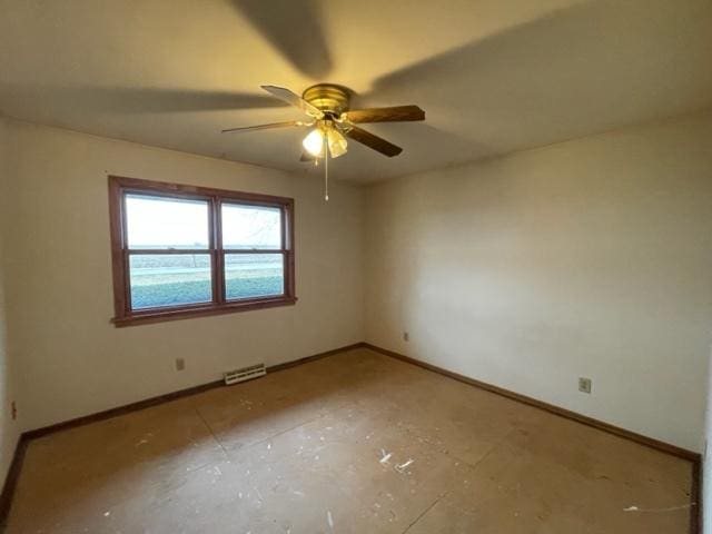 spare room featuring baseboards, visible vents, and ceiling fan