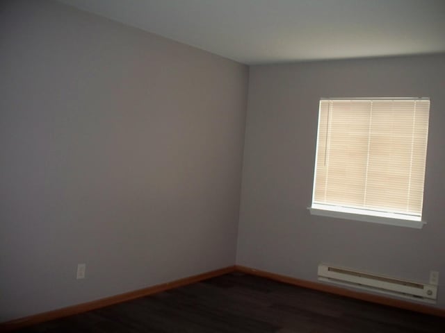 1357 Monomoy St Unit B1, Aurora, IL 60506 - empty room featuring a baseboard radiator and dark hardwood / wood-style flooring