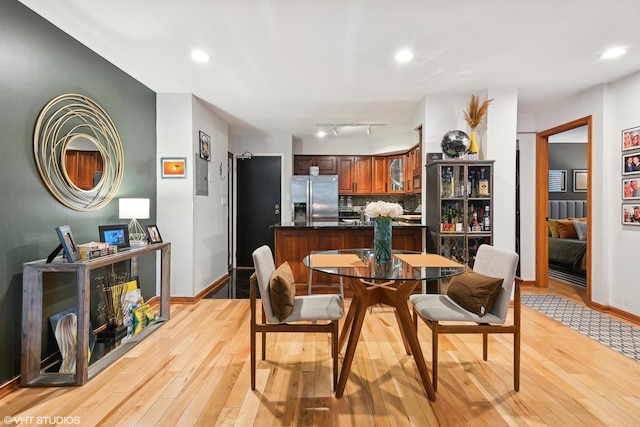 dining area featuring light hardwood / wood-style flooring and track lighting