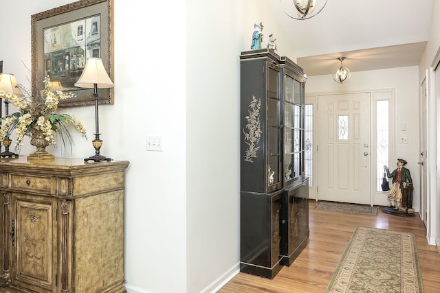 foyer featuring wood finished floors and baseboards