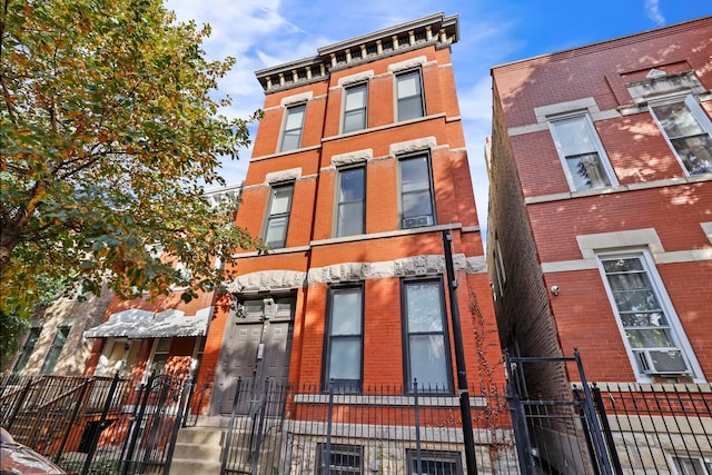 view of property featuring a fenced front yard and cooling unit