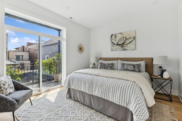 bedroom with light hardwood / wood-style flooring and access to outside