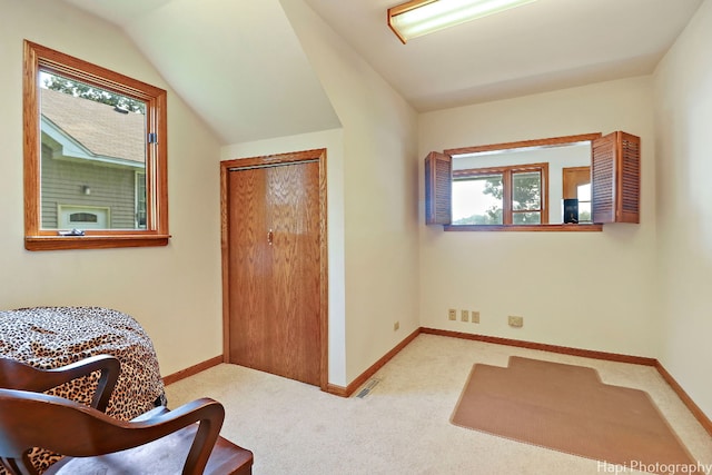 sitting room featuring lofted ceiling and light colored carpet