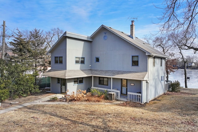 rear view of house featuring a porch, a water view, and central air condition unit