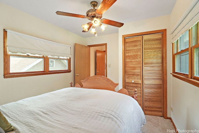 bedroom with carpet floors, a closet, and ceiling fan