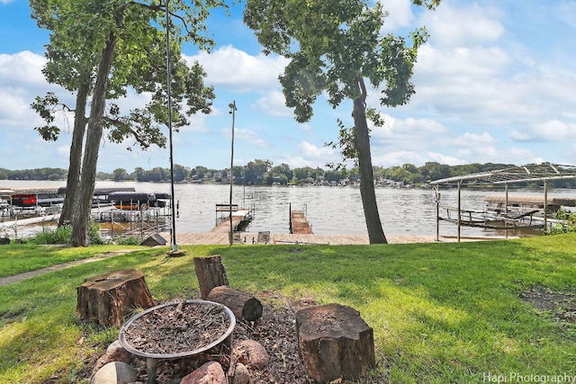 dock area with a water view and a yard