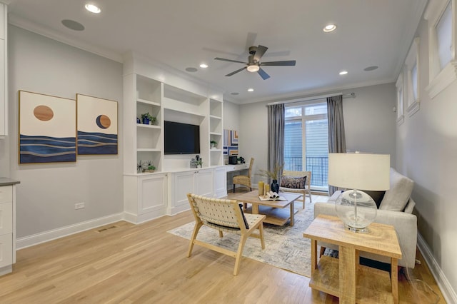 living room with ornamental molding, light hardwood / wood-style flooring, and ceiling fan