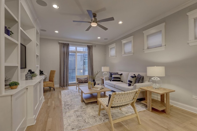 sitting room with ceiling fan, ornamental molding, and light hardwood / wood-style floors