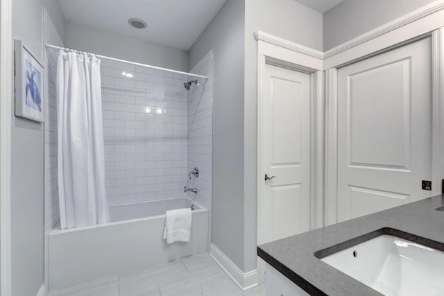 bathroom with shower / tub combo with curtain and vanity