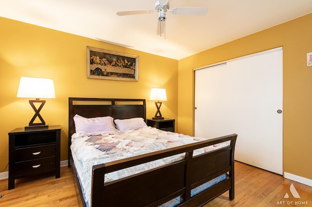 bedroom with light hardwood / wood-style flooring, a closet, and ceiling fan