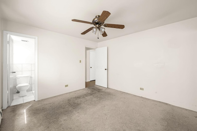 unfurnished bedroom featuring ceiling fan, ensuite bath, and light carpet