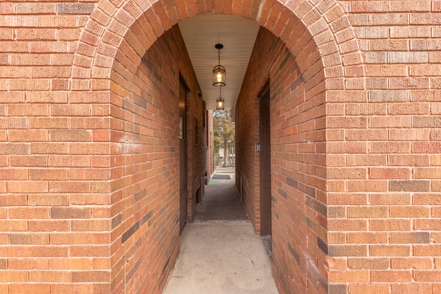 view of exterior entry with brick siding