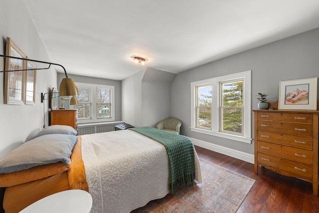 bedroom with dark wood-style floors and baseboards