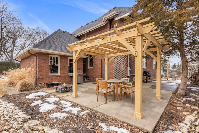 view of patio featuring a fire pit, outdoor dining space, grilling area, and a pergola