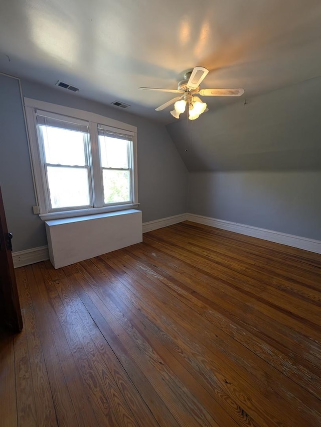 additional living space featuring lofted ceiling, dark wood-type flooring, and ceiling fan