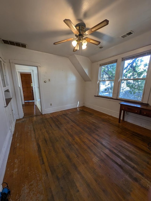 additional living space featuring dark wood-type flooring and ceiling fan