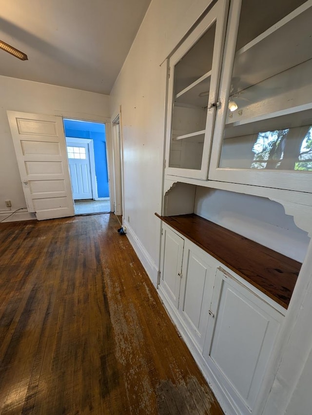 corridor featuring dark hardwood / wood-style floors