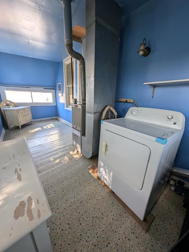 laundry area featuring heating unit and washer / dryer