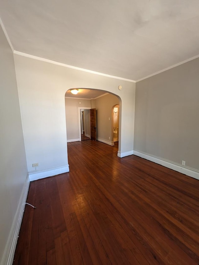 spare room with dark wood-type flooring and crown molding