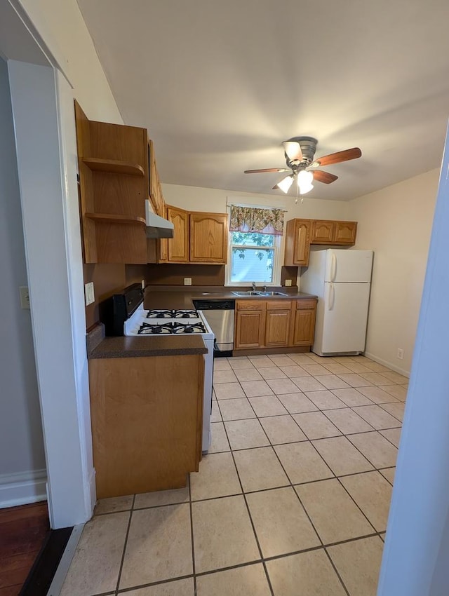 kitchen with sink, light tile patterned floors, white refrigerator, range with gas stovetop, and dishwasher