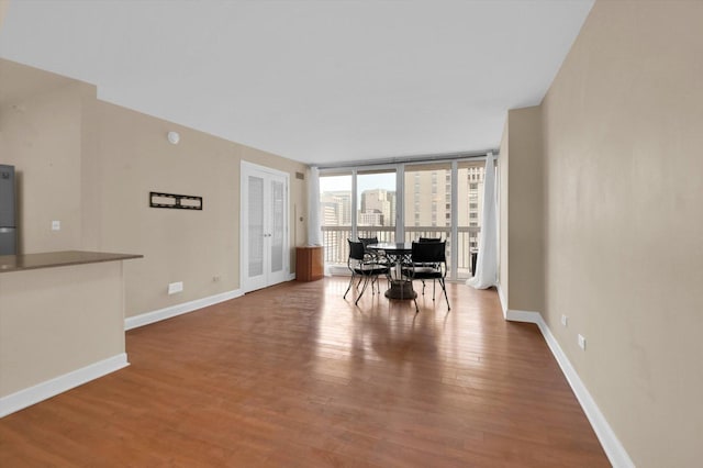 dining room featuring expansive windows and wood-type flooring