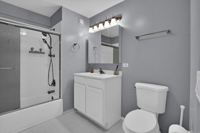 full bathroom featuring vanity, bath / shower combo with glass door, tile patterned floors, and toilet