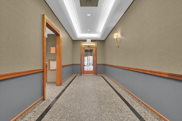 hallway with a tray ceiling