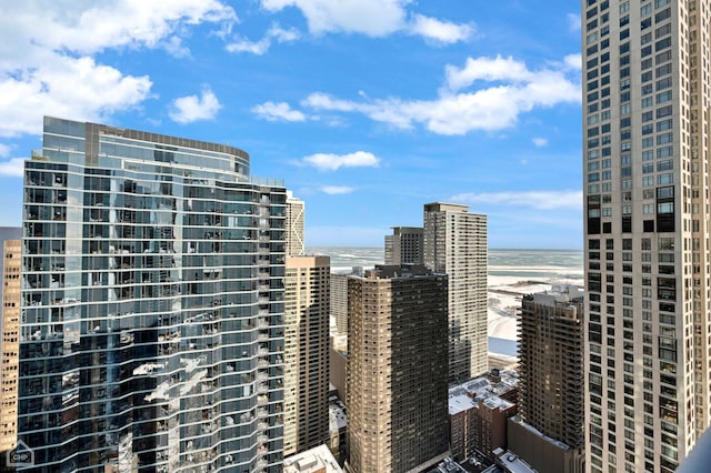 view of city featuring a water view and a beach view