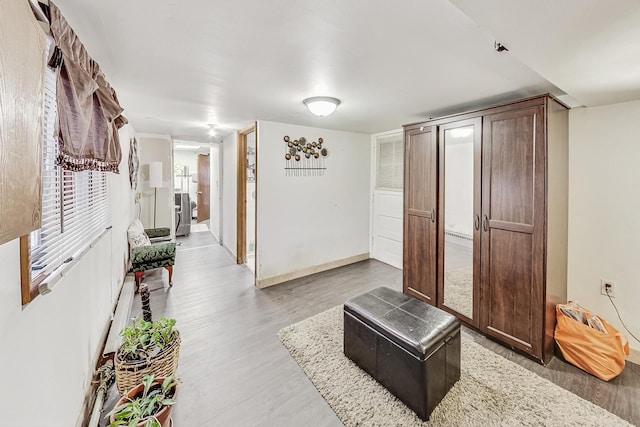 hallway with hardwood / wood-style flooring