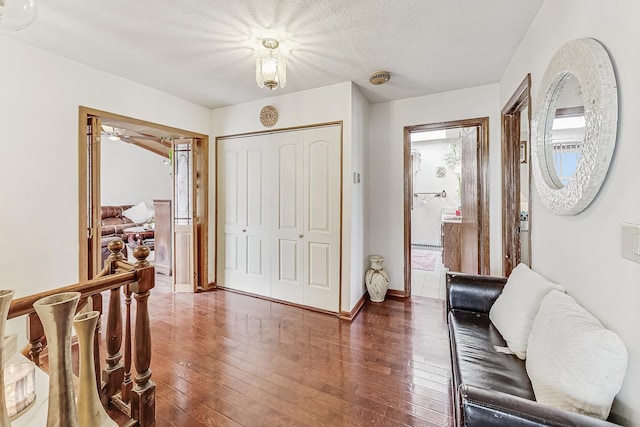 foyer featuring dark hardwood / wood-style flooring and a textured ceiling