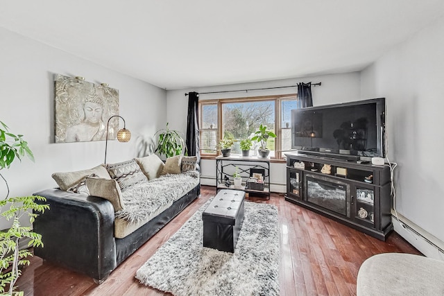 living room with hardwood / wood-style floors and a baseboard heating unit