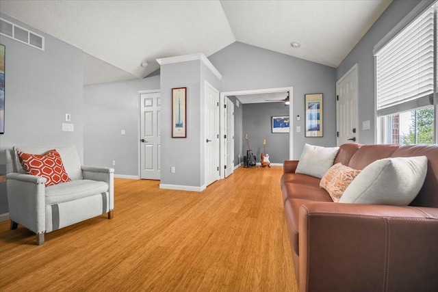 living room with vaulted ceiling and light hardwood / wood-style flooring